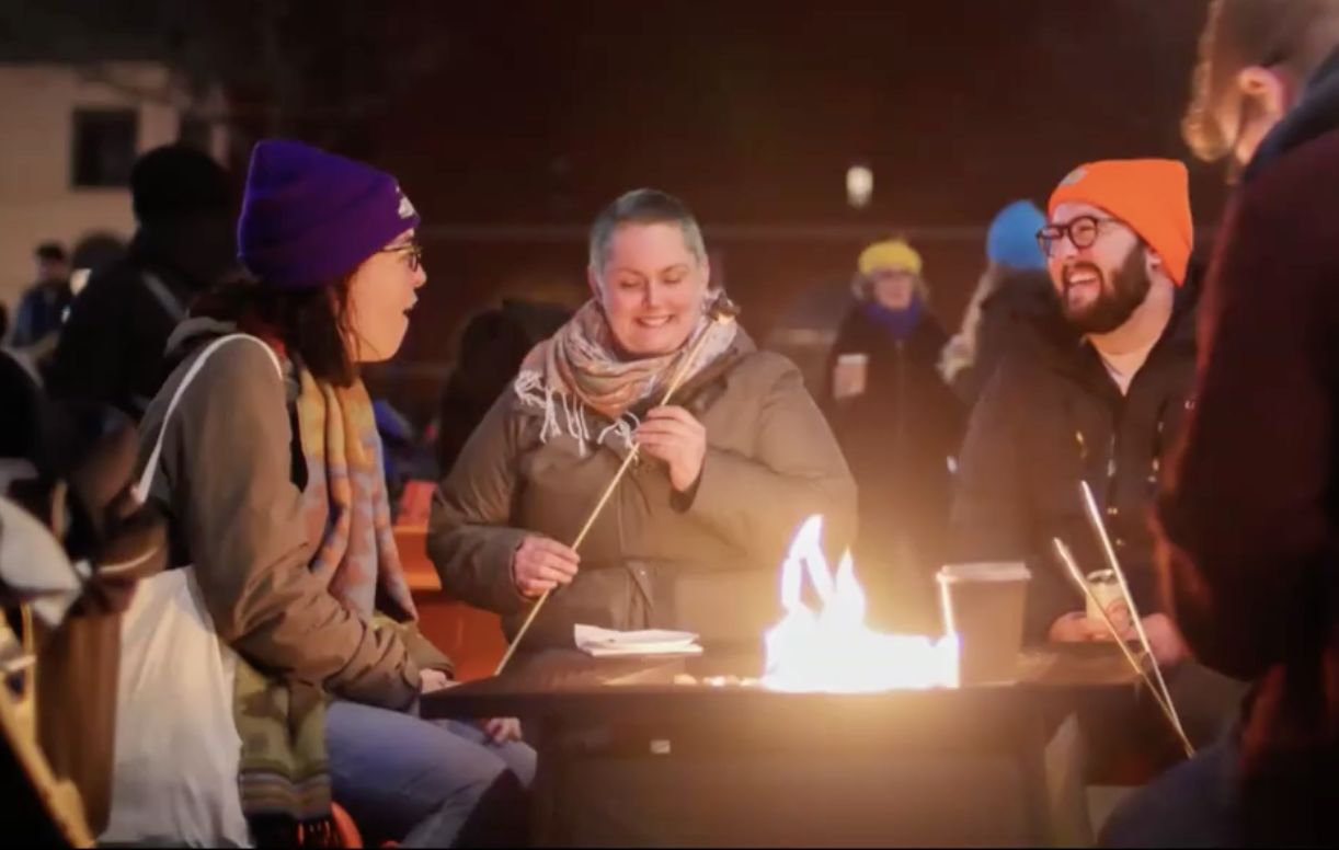 people toasting marshmallows at night